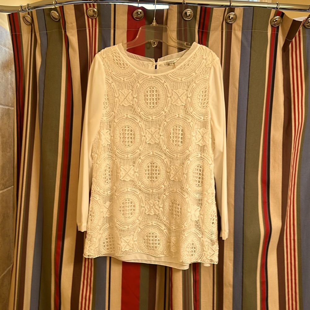 Dressy cream top with crochet overlay.